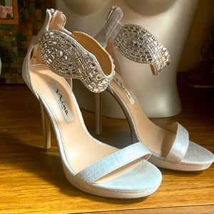 Gorgeous silver jeweled high heels.size 7 1/2 excellent condition wore once.